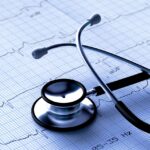 Black stethoscope and ECG